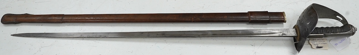 An 1898 pattern British NCO’s sword with leather scabbard, Edward VII cipher to guard, the blade with government stamps, issued 1903, blade 82cm. Condition - fair, some wear overall